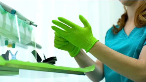 Medical Professional Wearing Green Disposable Gloves